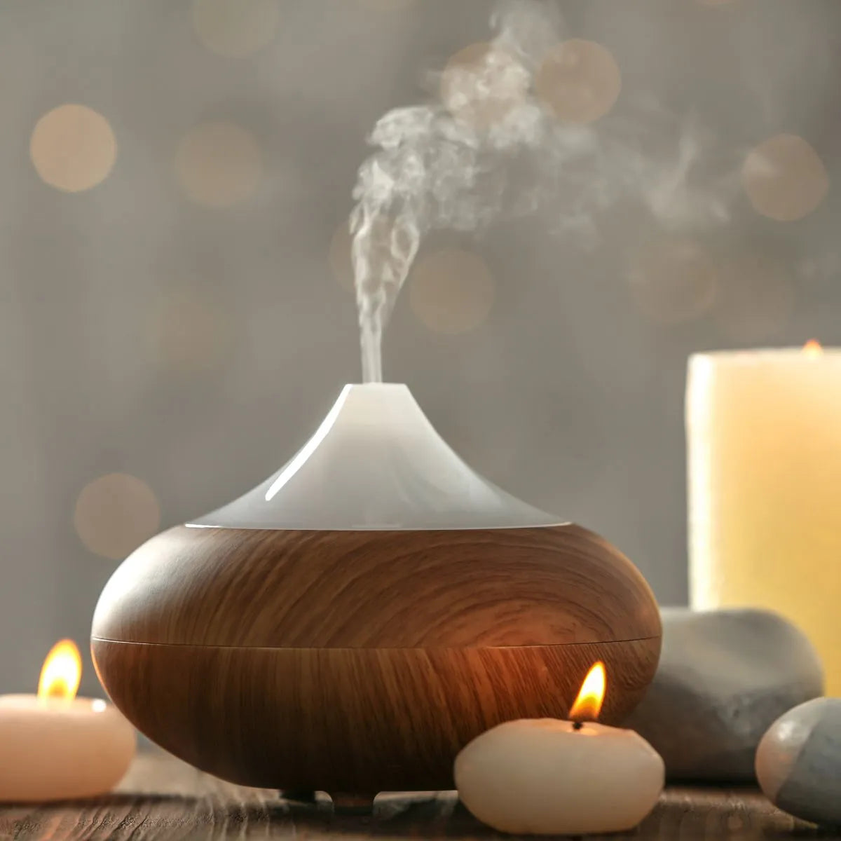 Casino Gold fragrance oil diffuser emitting steam in a peaceful, candle-lit setting