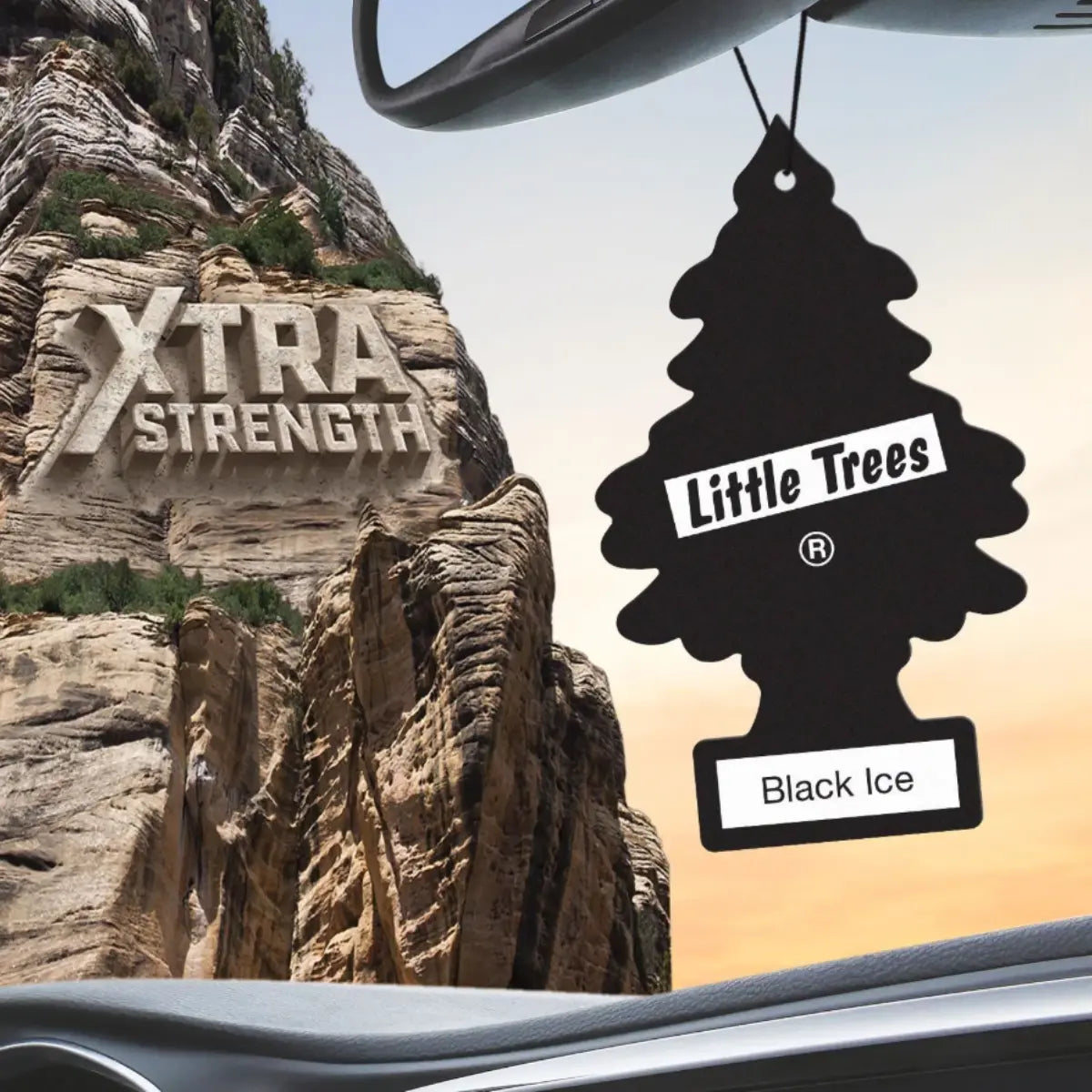 Black Ice Little Trees air freshener hanging from rearview mirror with Xtra Strength branding in background