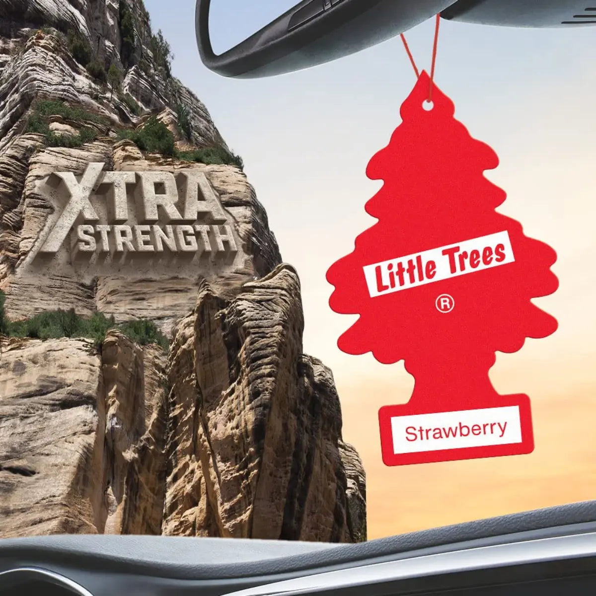 Little Trees Strawberry Xtra Strength air freshener hanging inside car window