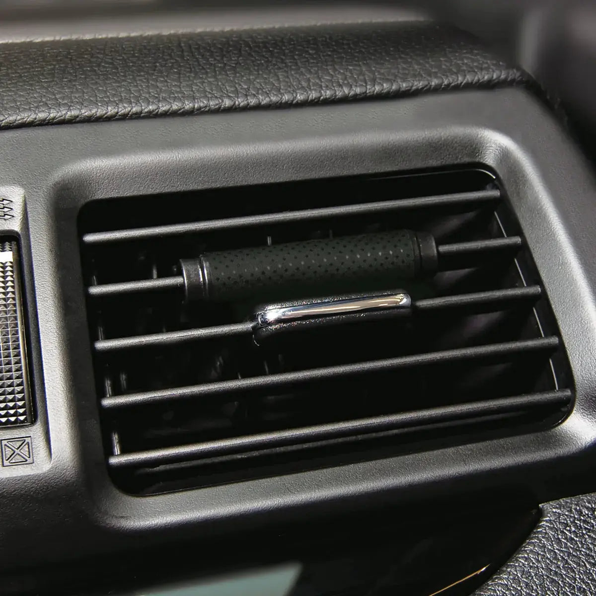 Little Trees Vanillaroma Vent Wrap installed on a car air vent, providing a sweet and comforting vanilla fragrance.