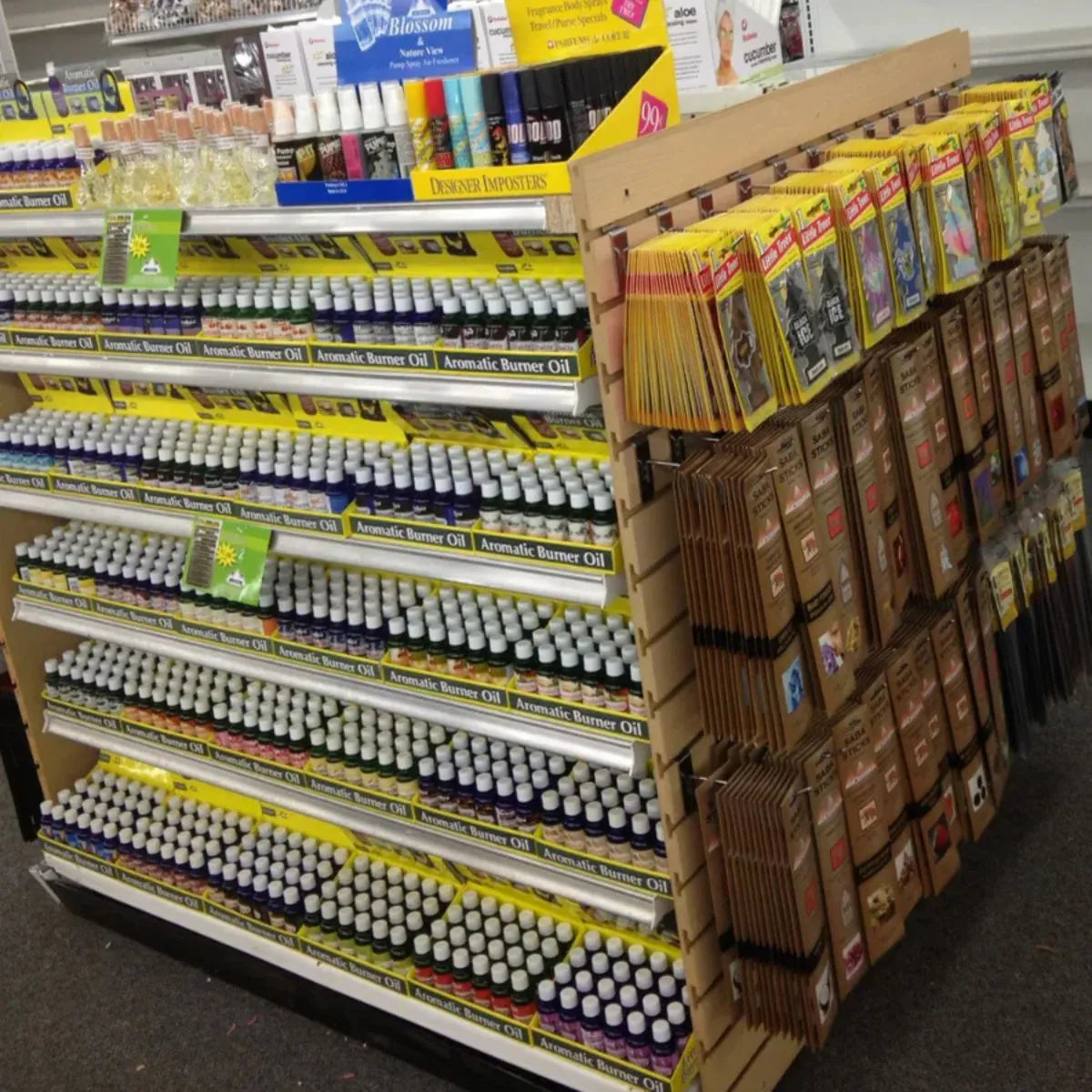 Full shelf retail display of Casino Gold fragrance oils and incense in a store setting
